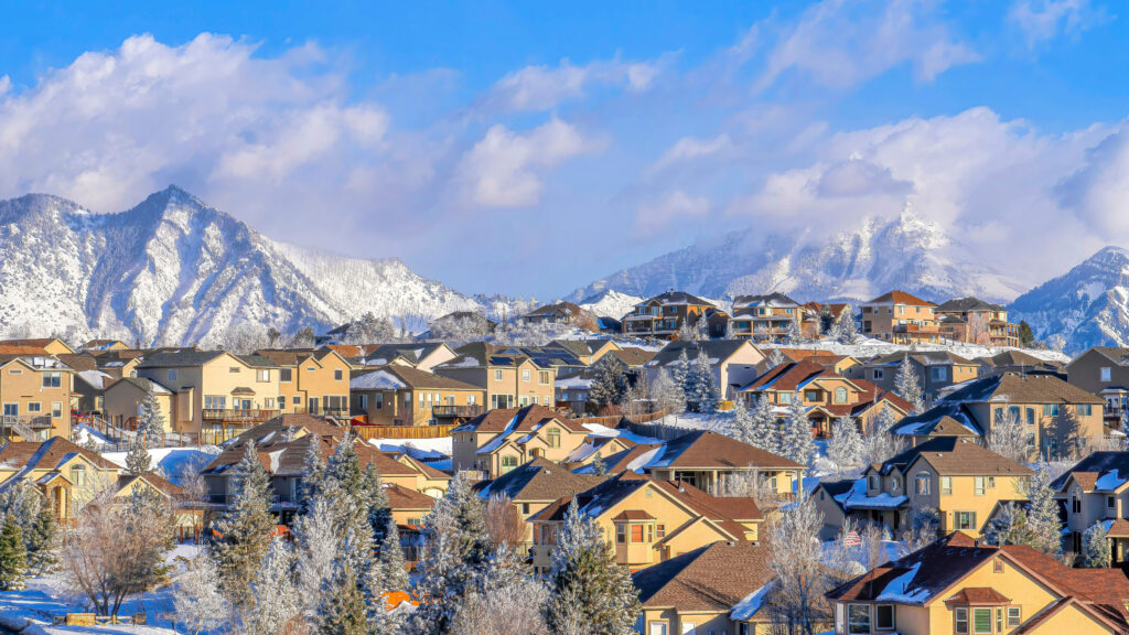 homes covering snowy foothills in highland, utah 